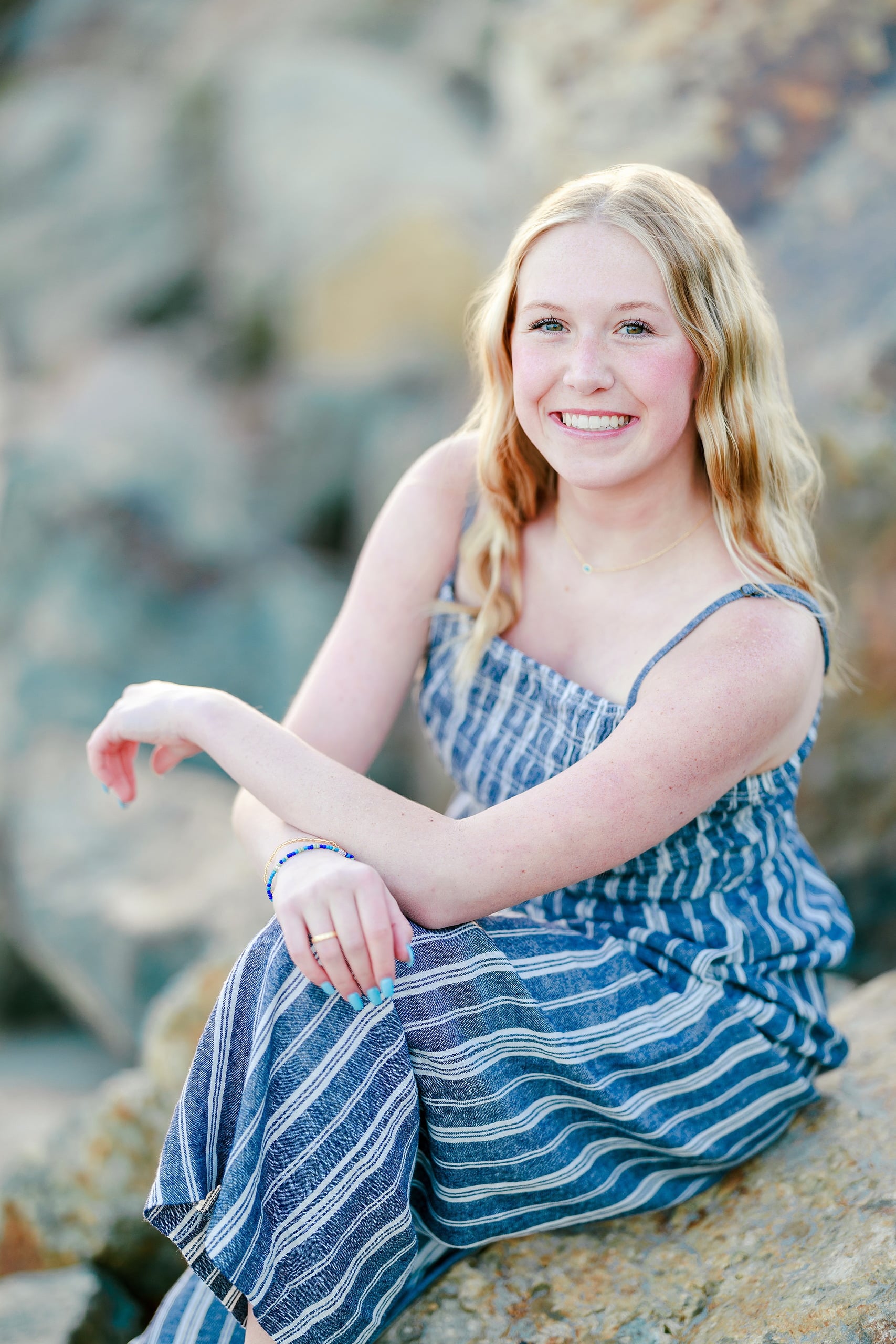 Sisters & Senior Portraits at the Del — 16 Ashlyn in striped dress walking along rocky beach, glancing back