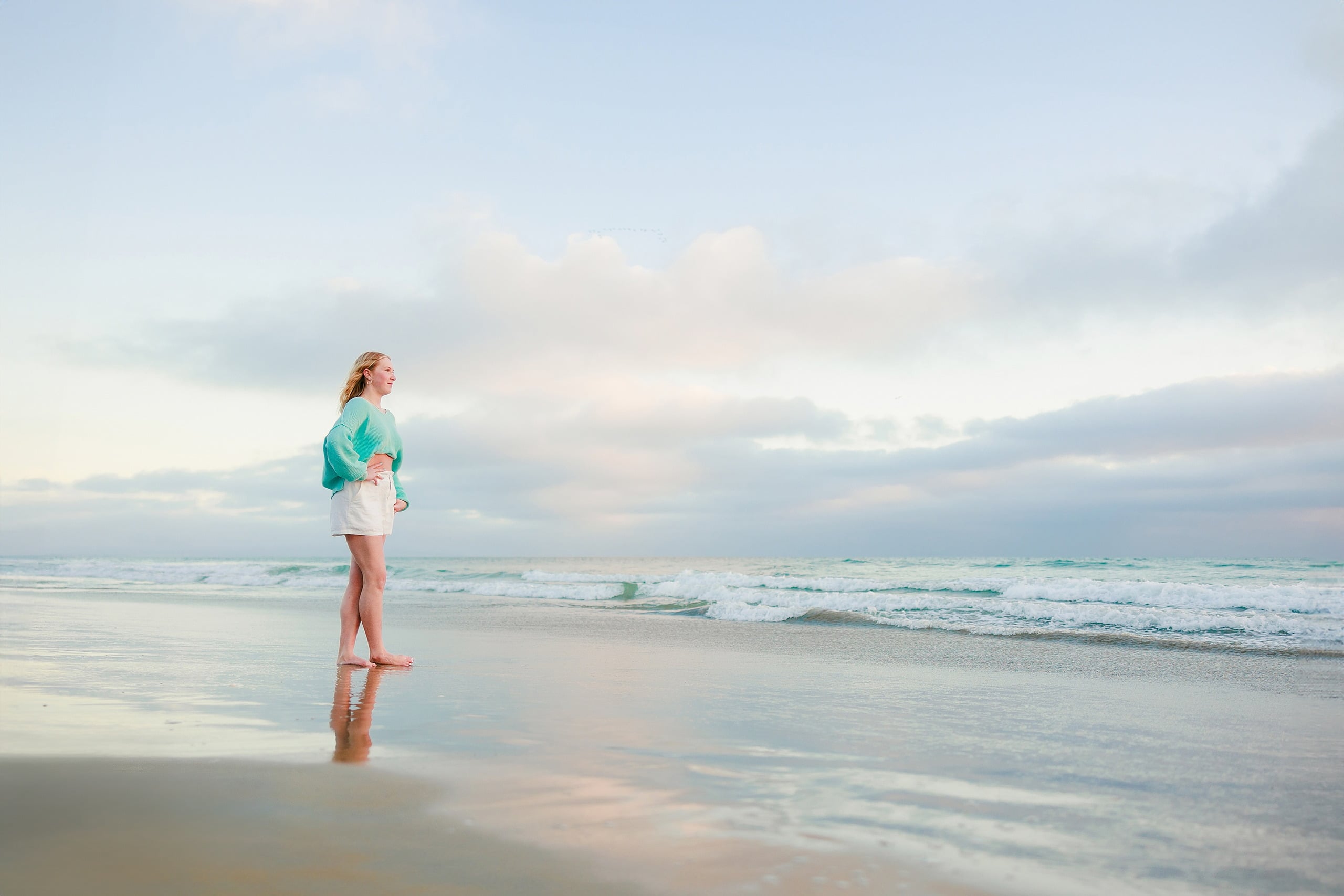 Sisters & Senior Portraits at the Del — 26 Family of four in casual wear wading together in ocean waves and shallow water