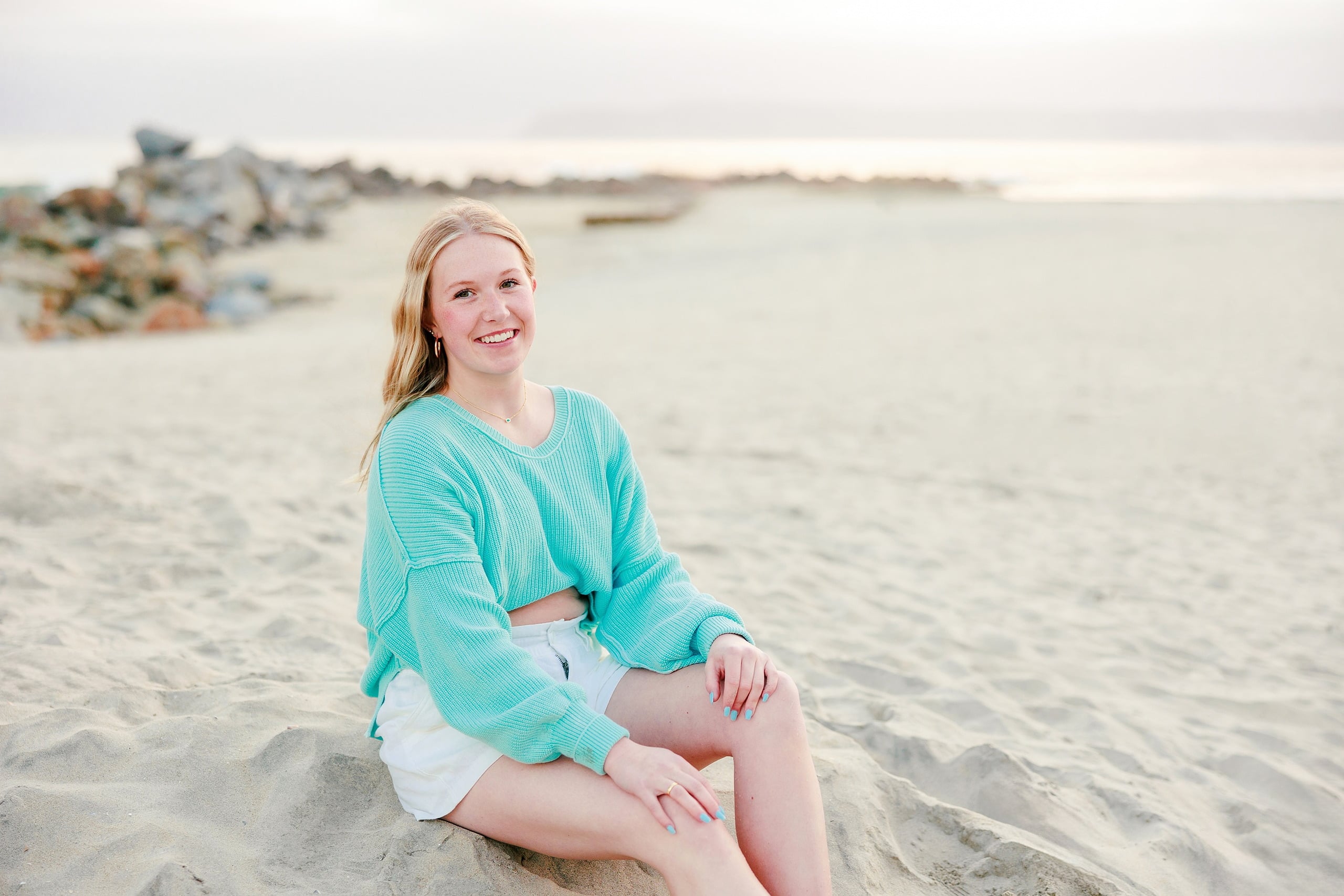 Sisters & Senior Portraits at the Del — 28 Two sisters on beach holding hands, one in blue floral top, one in turquoise
