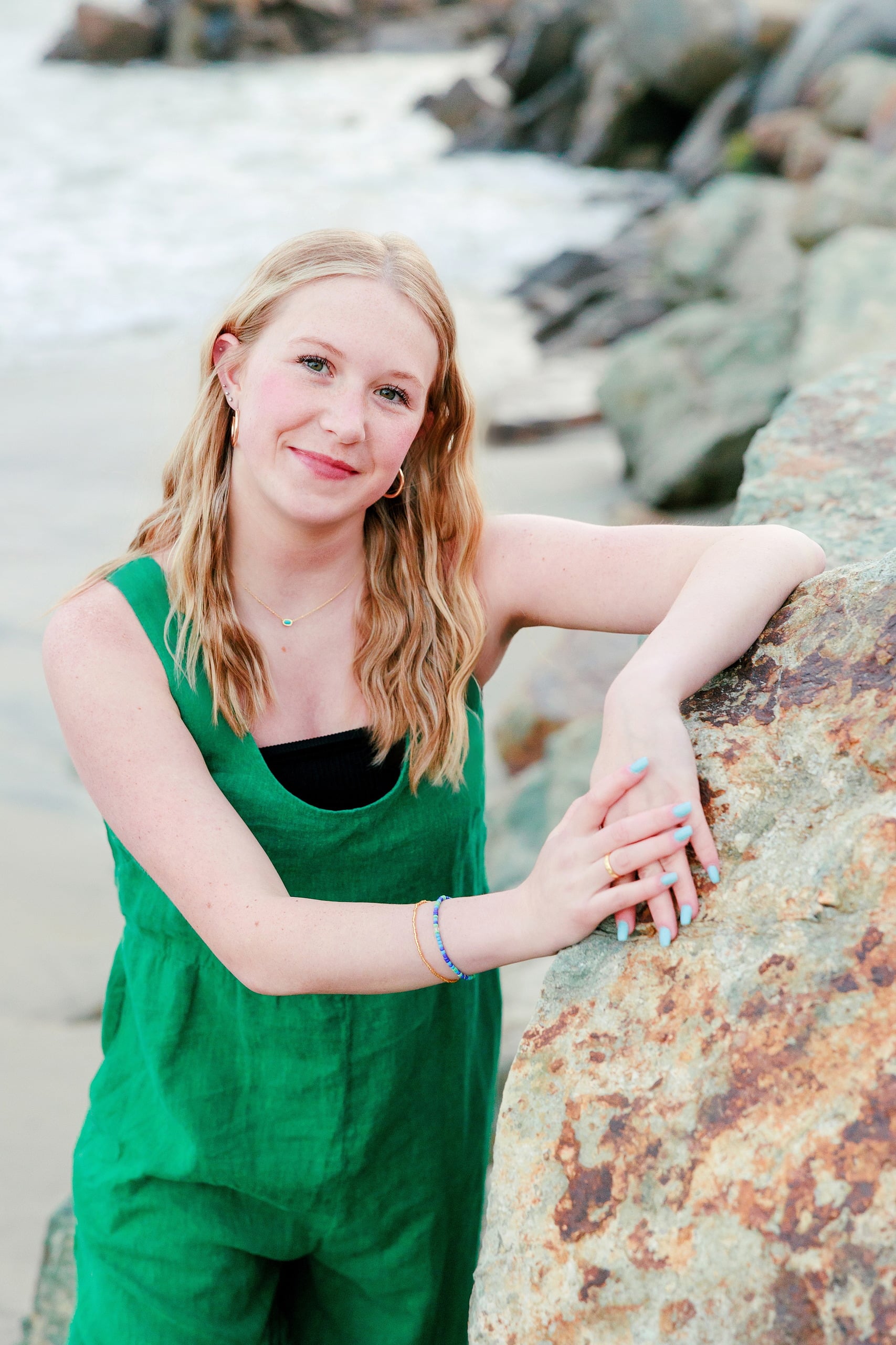 Sisters & Senior Portraits at the Del — 36 Teen in green sleeveless dress leaning against large rusty rock formation