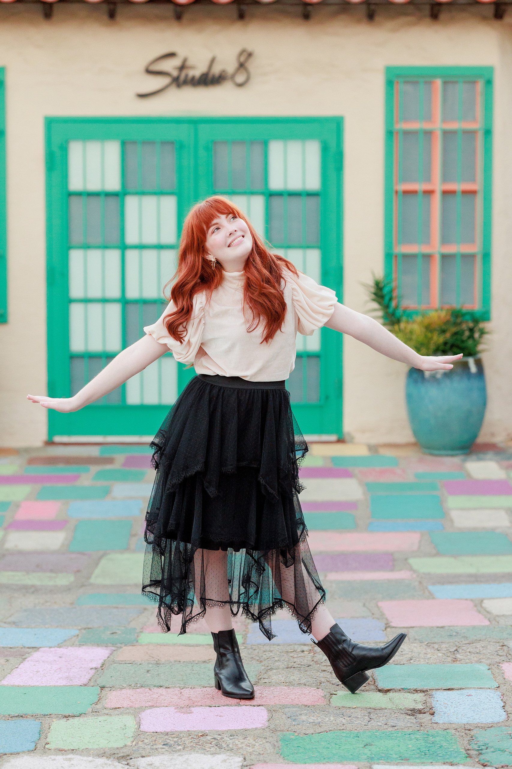 Six Years Later: Family Photos in Balboa Park — 37 Emma smiling in artistic setting at Spanish Village Art Center