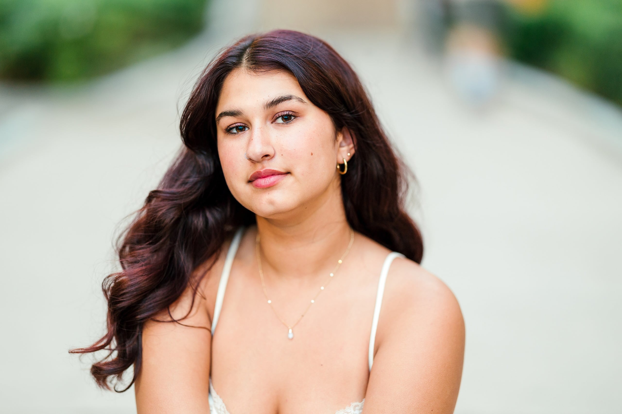 Sonia’s Senior Portraits in Balboa Park — 19 A young woman posed by the coastline for her senior portrait session
