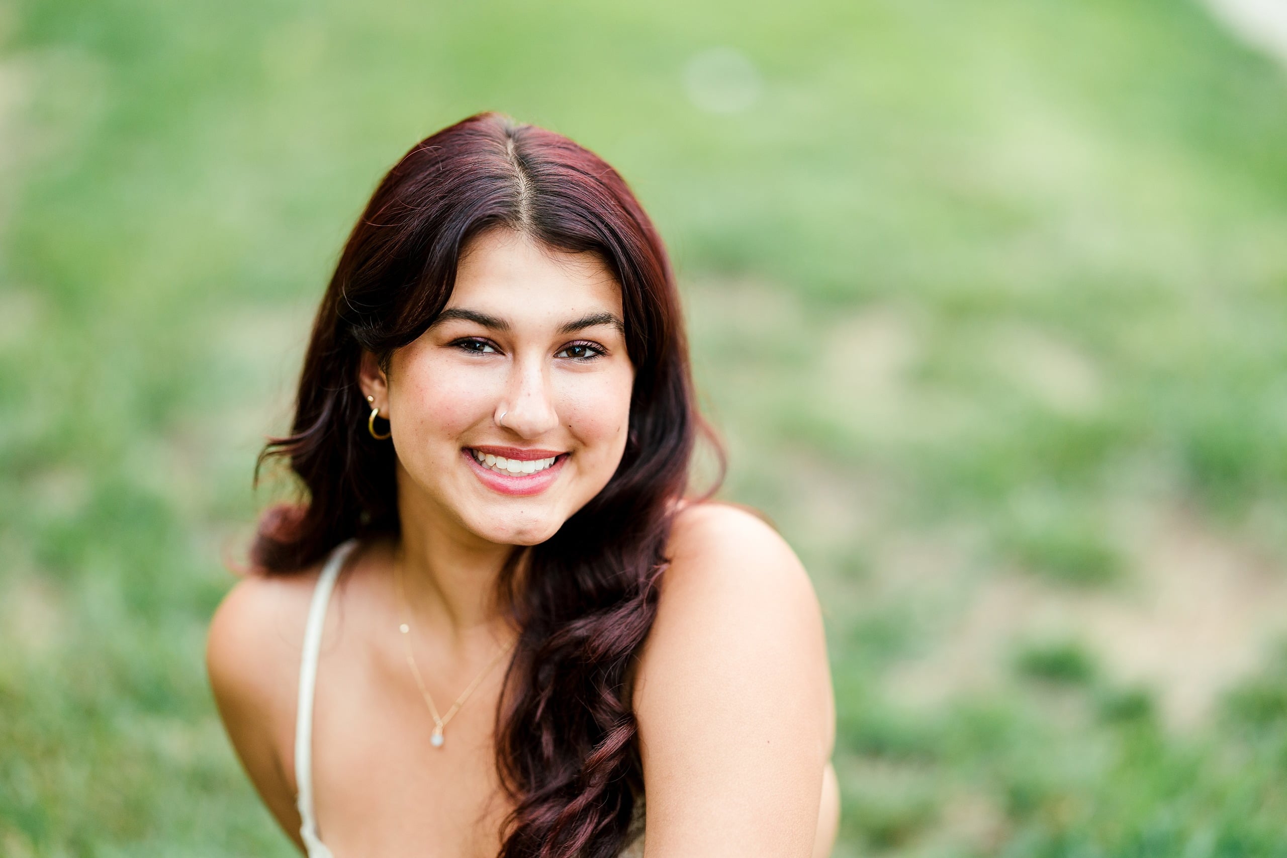 Sonia’s Senior Portraits in Balboa Park — 20 A senior in a relaxed pose at Balboa Park for her senior portraits