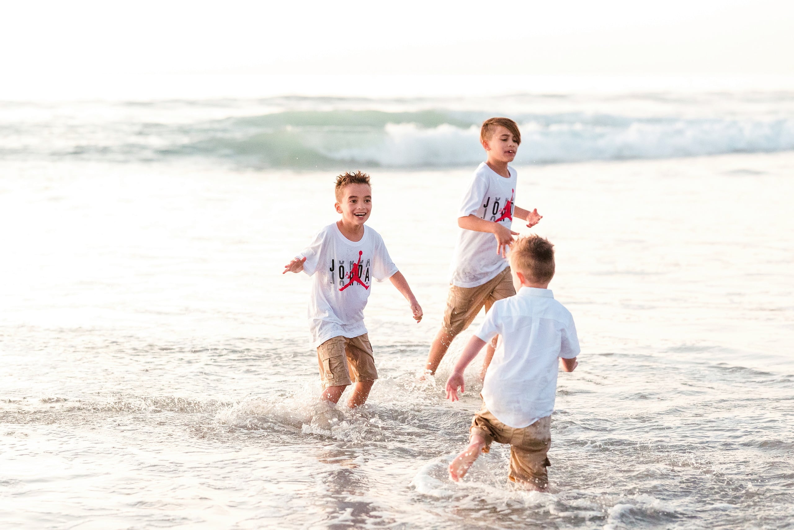 The Day the Sun Stood Still — 11 Three children running and playing in ocean waves at Del Mar beach