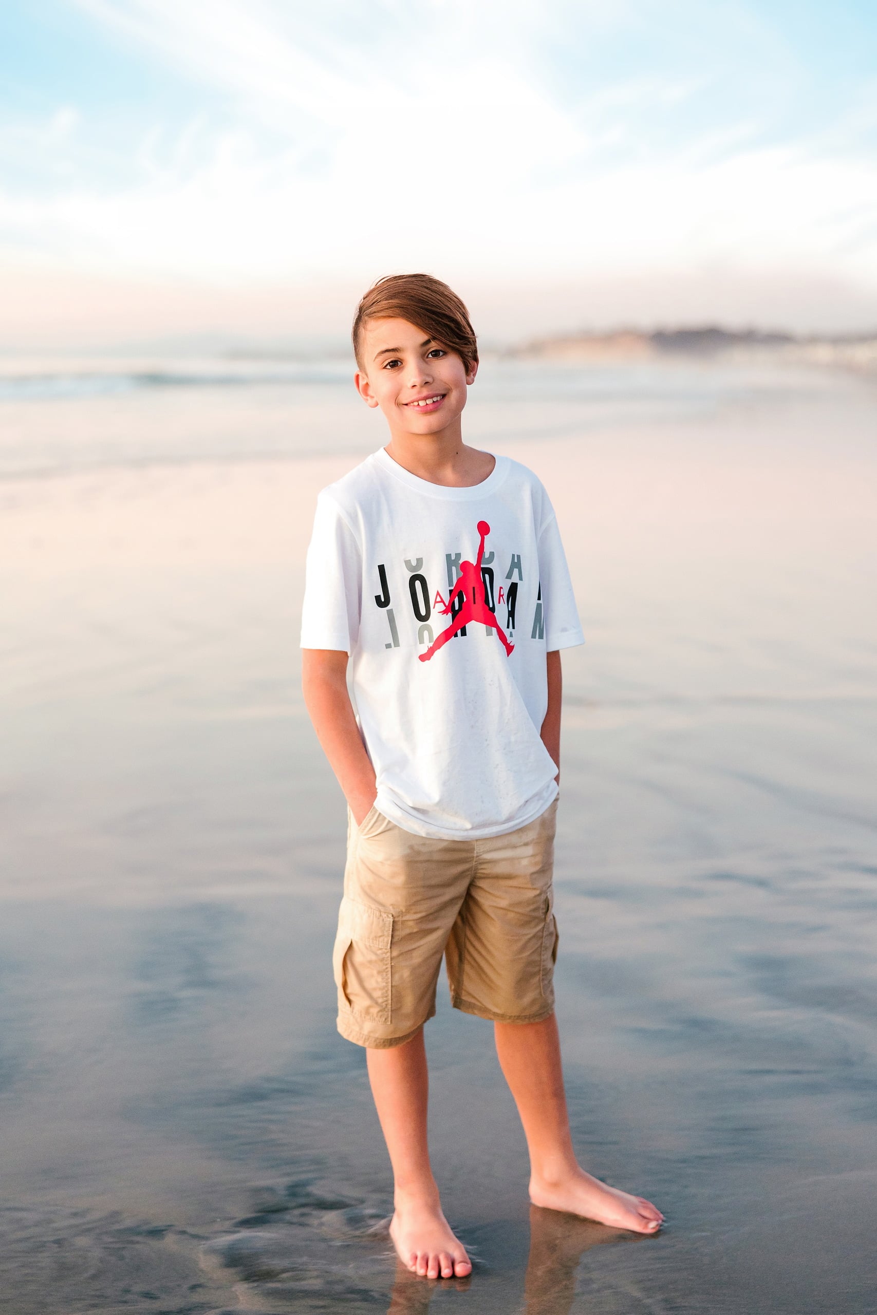 The Day the Sun Stood Still — 21 Boy in white shirt standing on wet beach sand at Del Mar at golden hour