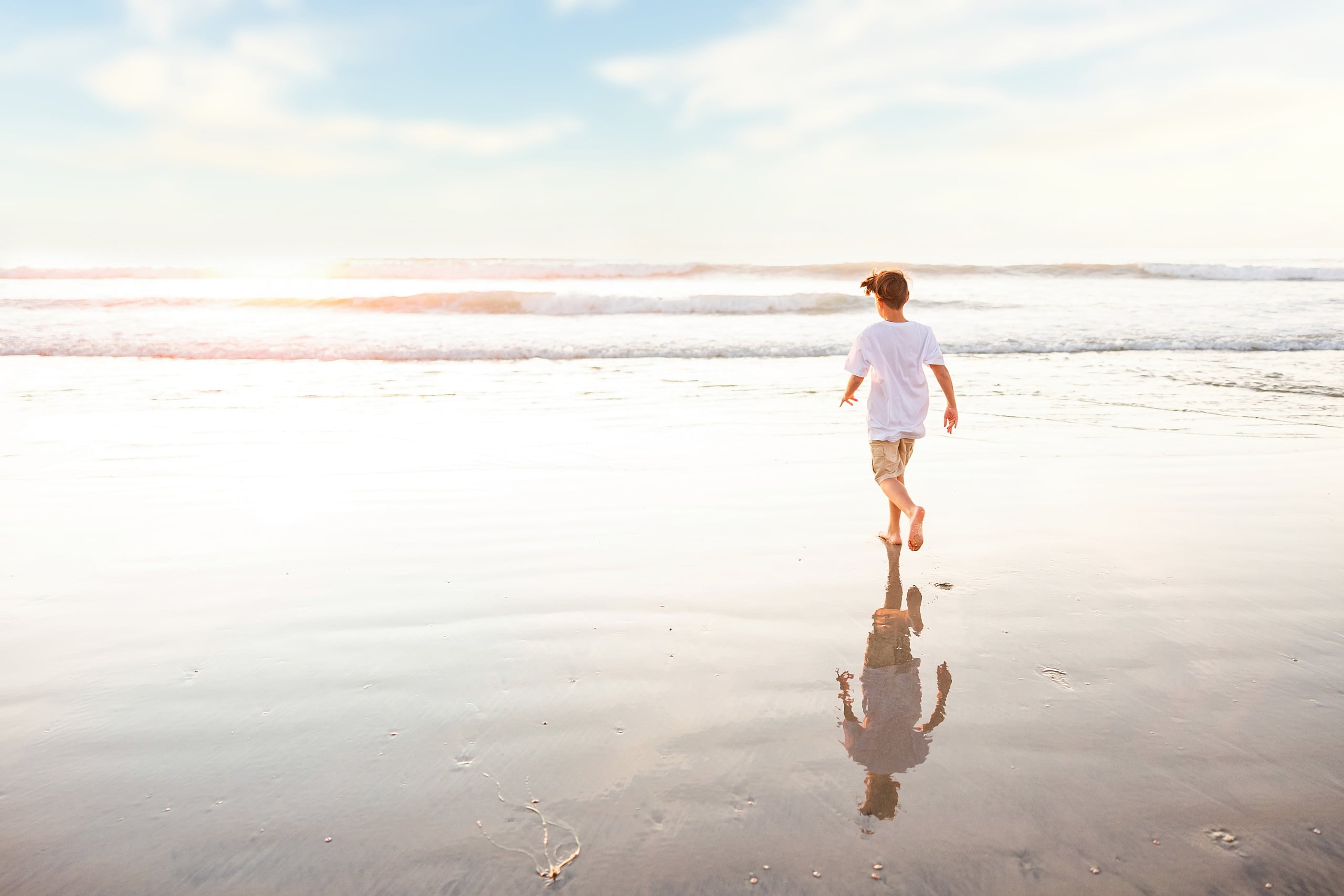 The Day the Sun Stood Still — 26 Child running along wet sand at water's edge at Del Mar beach