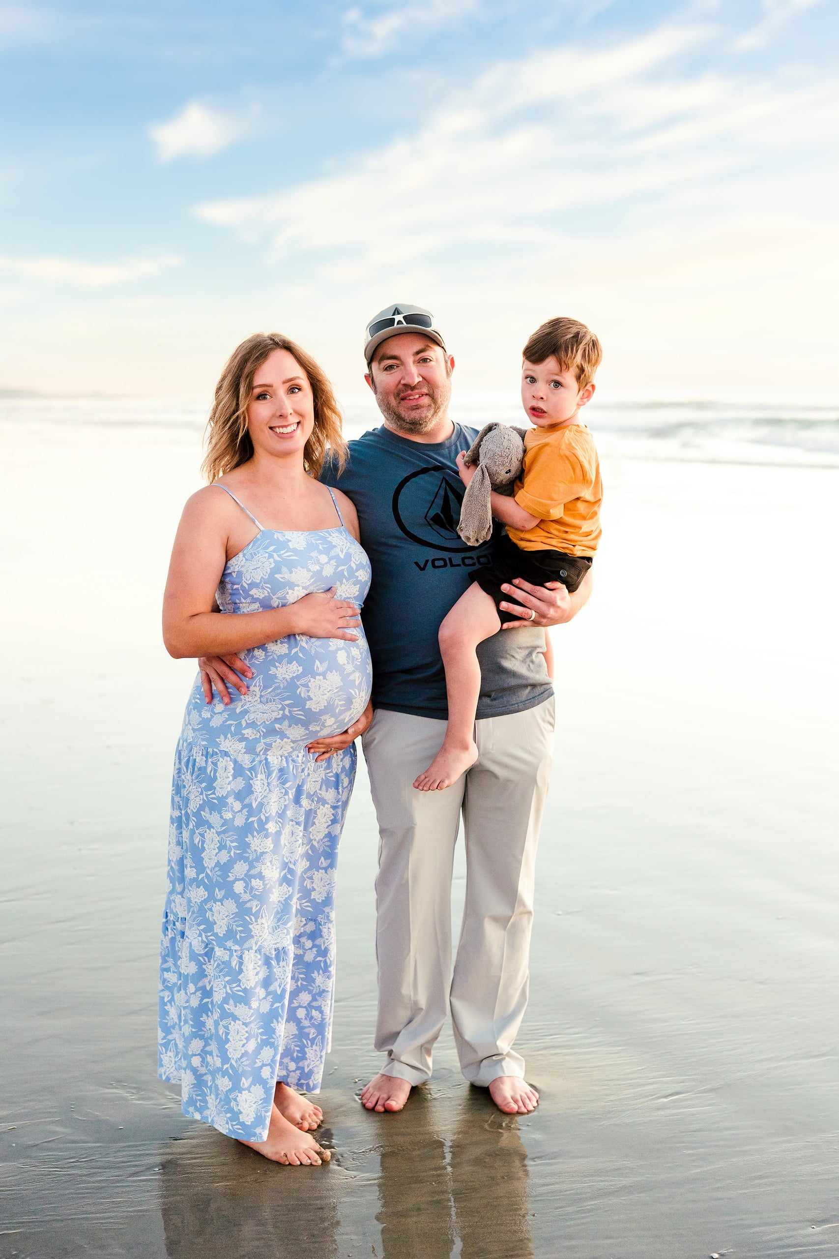 The Day the Sun Stood Still — 33 Woman holding toddler with man and child on wet beach sand at Del Mar