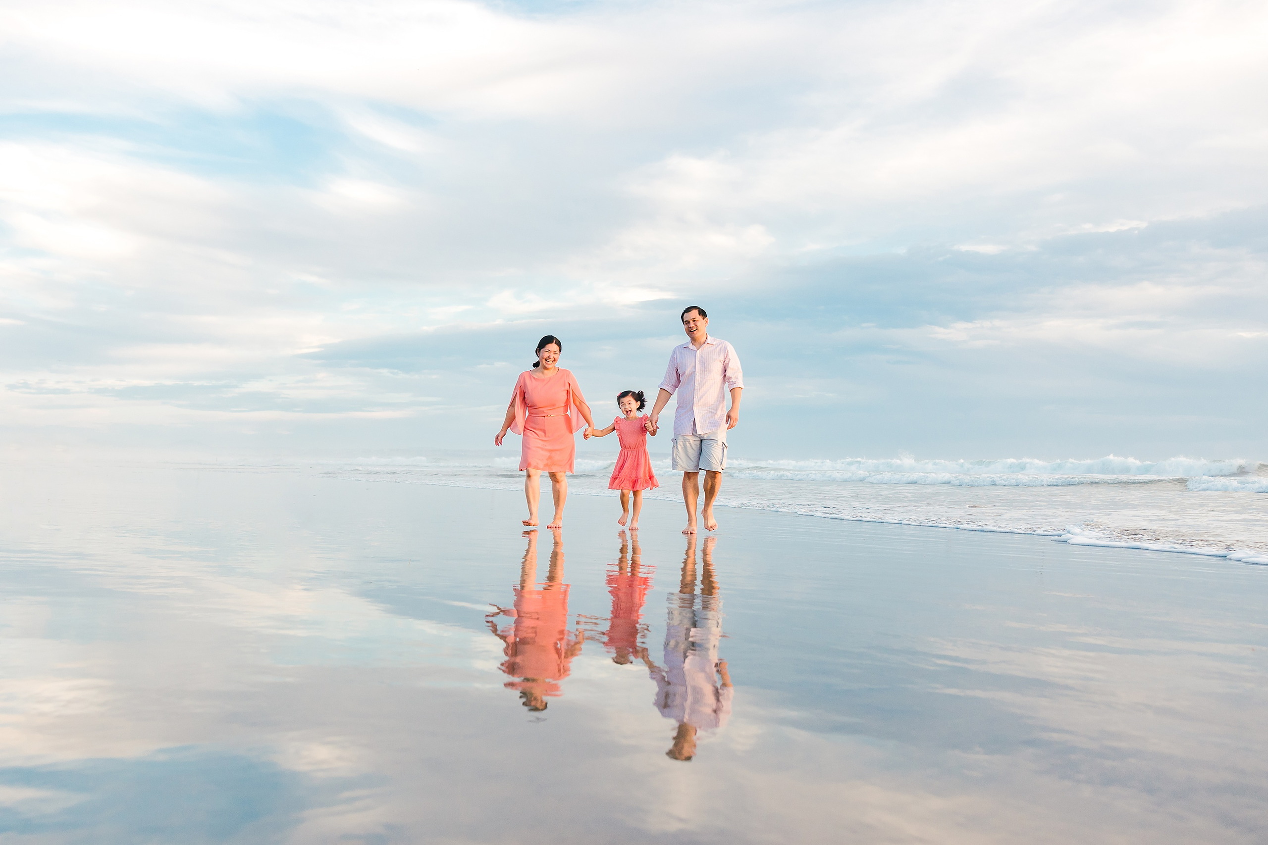 Turning Five on Coronado — 19 Ava and her family walking together in shallow water at Coronado Beach