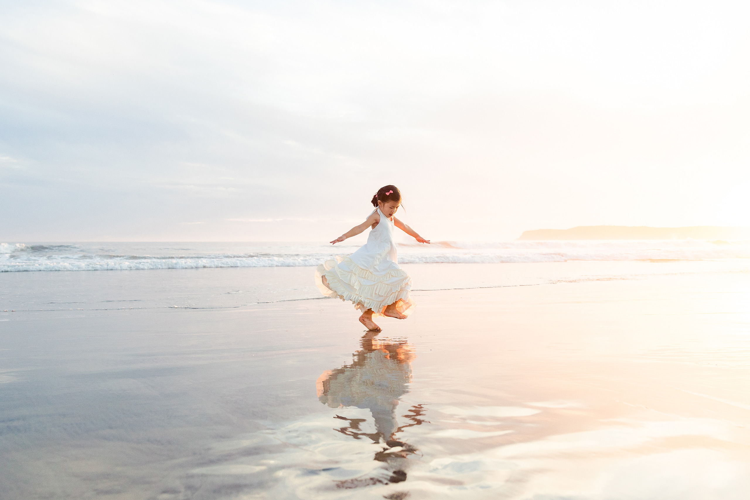 Turning Five on Coronado — 28 Ava running playfully through shallow water at sunset at Coronado