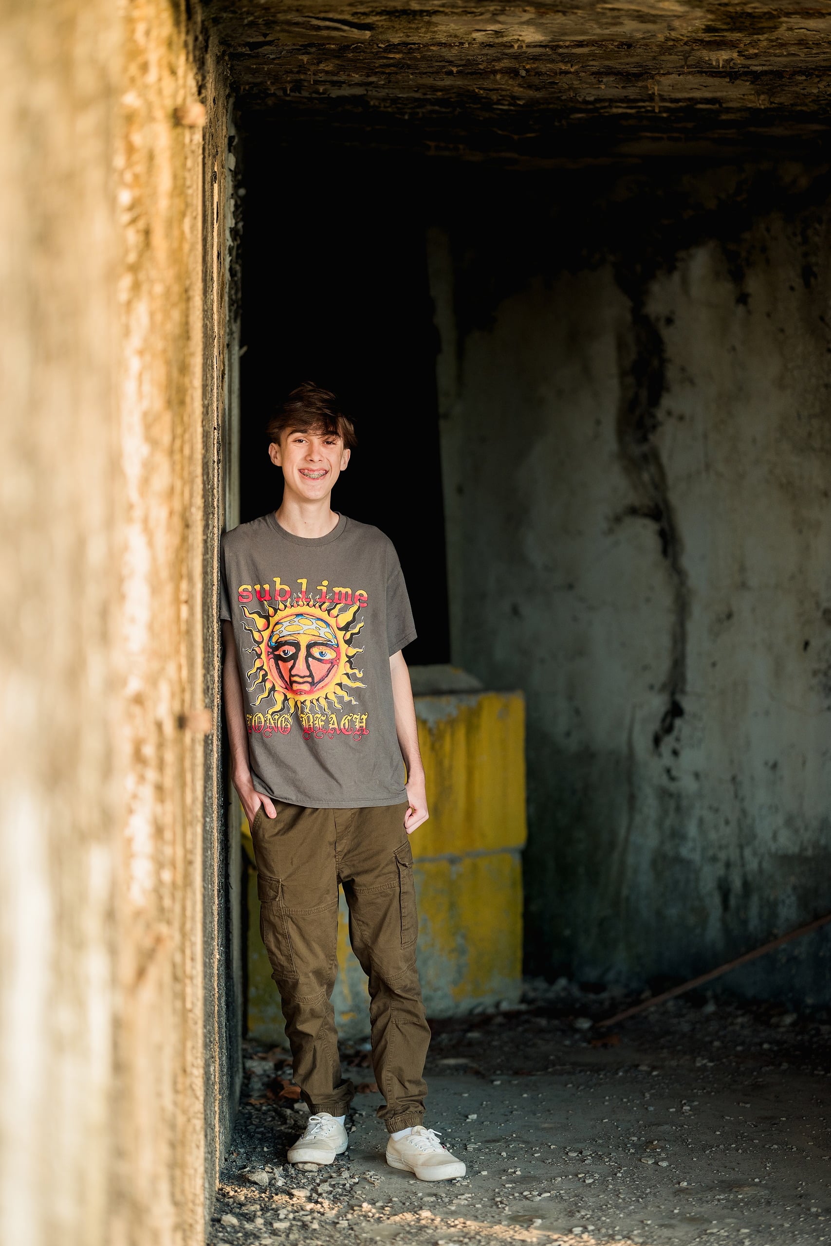 Zach’s Senior Portraits — 06 Zach in brick doorway at Fort Monroe Battery, aging urban setting