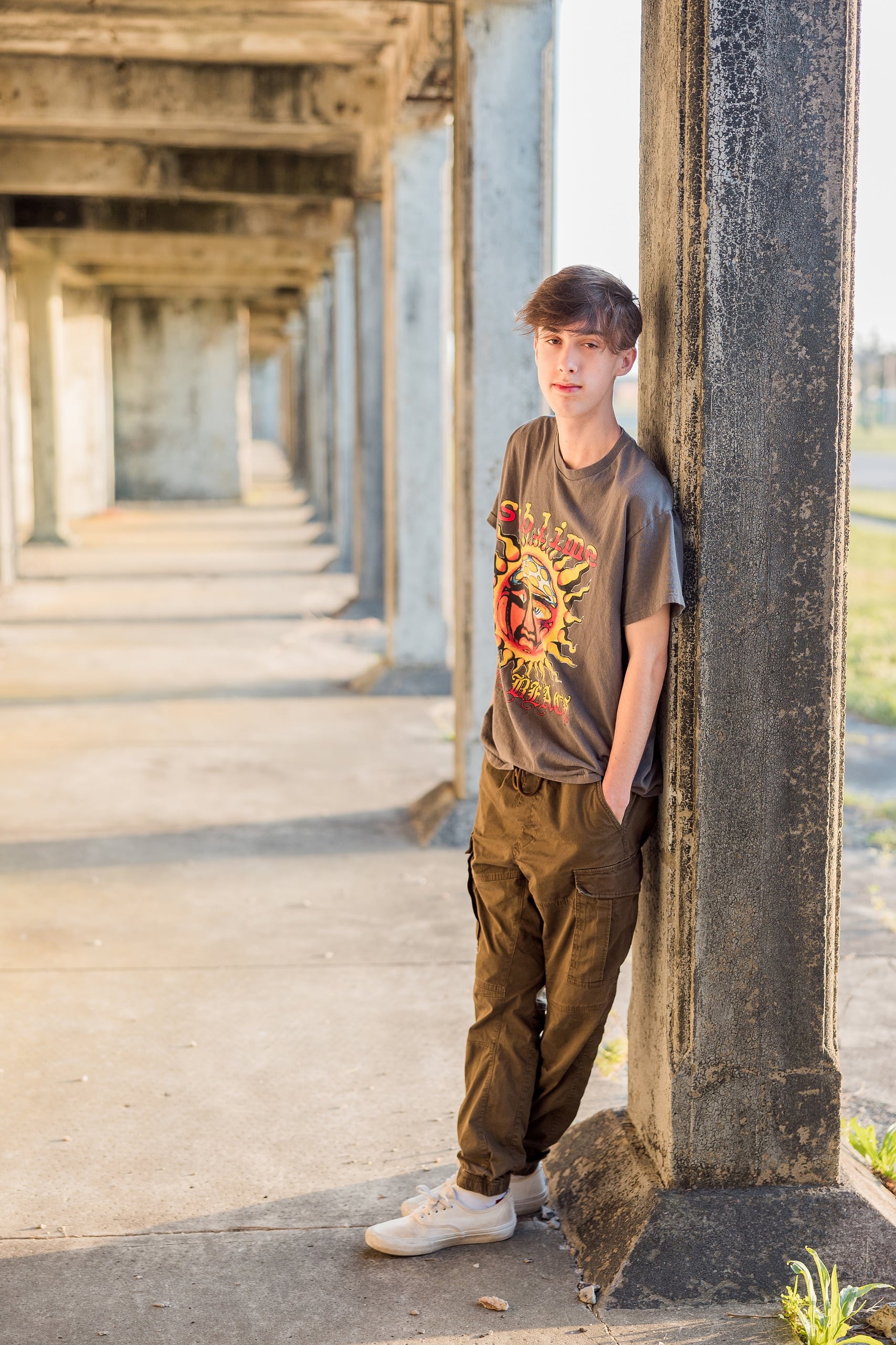 Zach’s Senior Portraits — 12 Zach standing in passage with columns receding into distance
