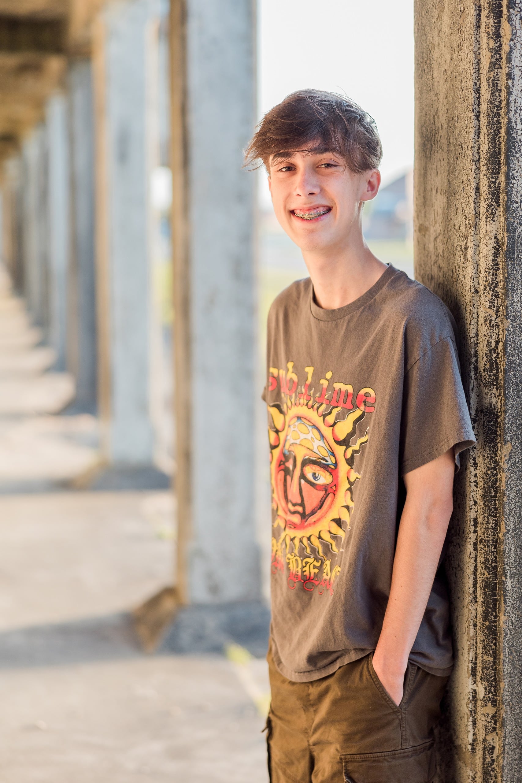 Zach’s Senior Portraits — 13 Zach smiling in golden light at Fort Monroe, close-up portrait