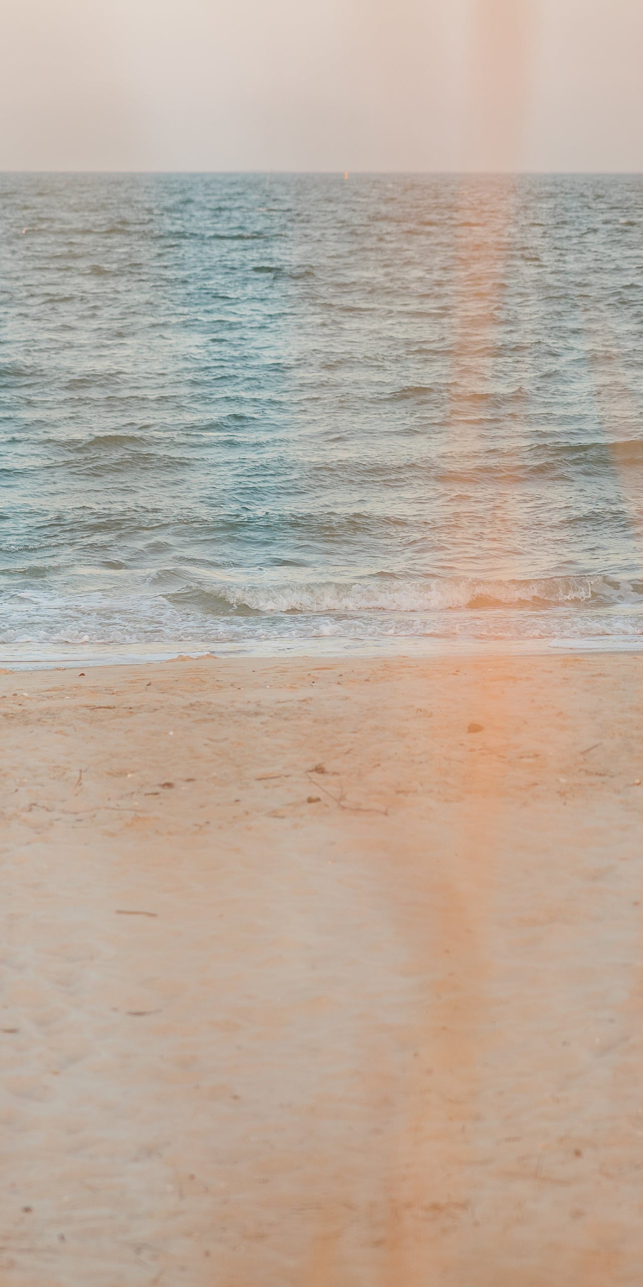 Zach’s Senior Portraits — 19 Empty beach at sunset with soft pink and gold light on water