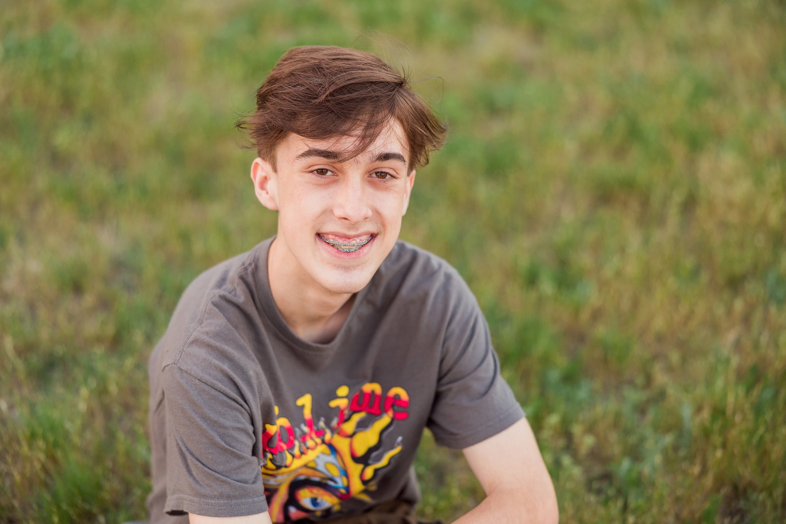 Zach’s Senior Portraits — 20 Close-up of beach grasses with ocean horizon and sky beyond