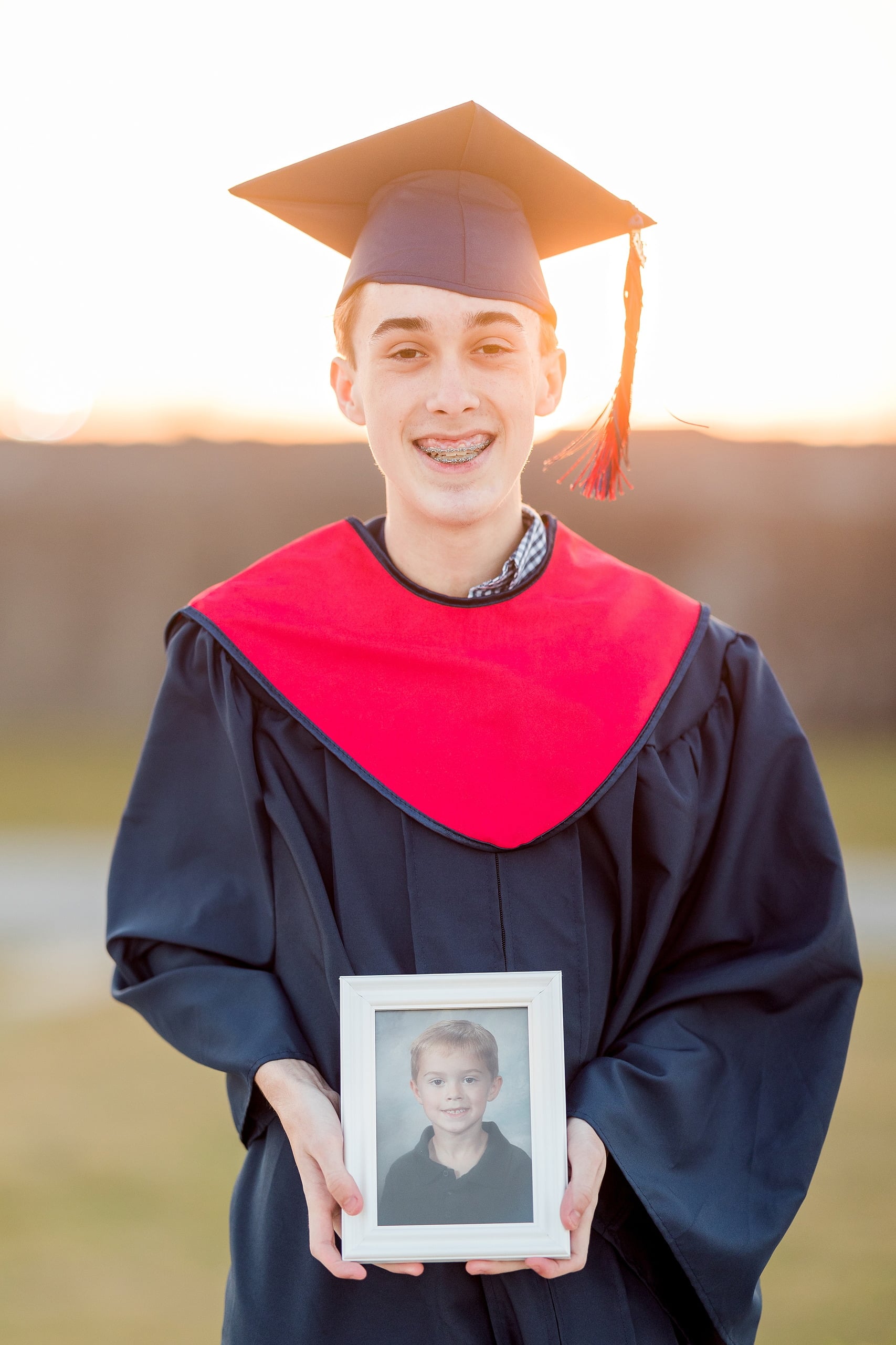 Zach’s Senior Portraits — 21 Zach smiling in grassy field, natural light, close-up portrait