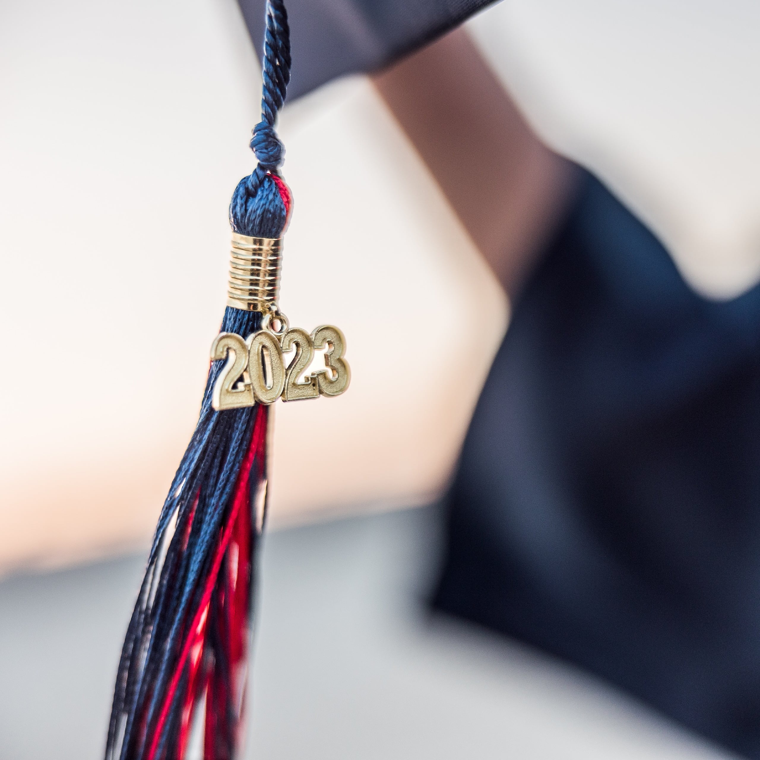 Zach’s Senior Portraits — 22 Zach in graduation cap and gown holding framed childhood photo
