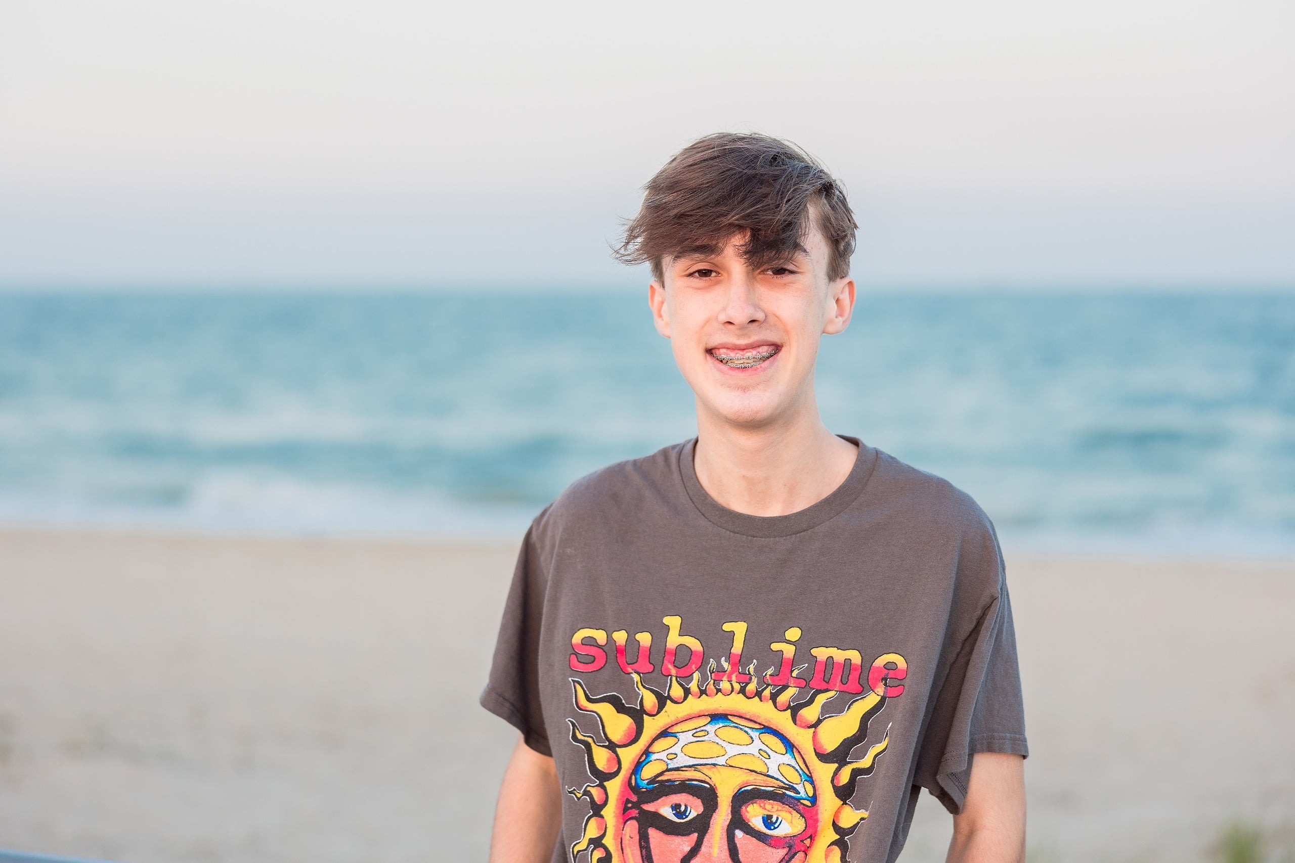Zach’s Senior Portraits — 28 Beach grasses in close-up with ocean and sky soft-focused behind