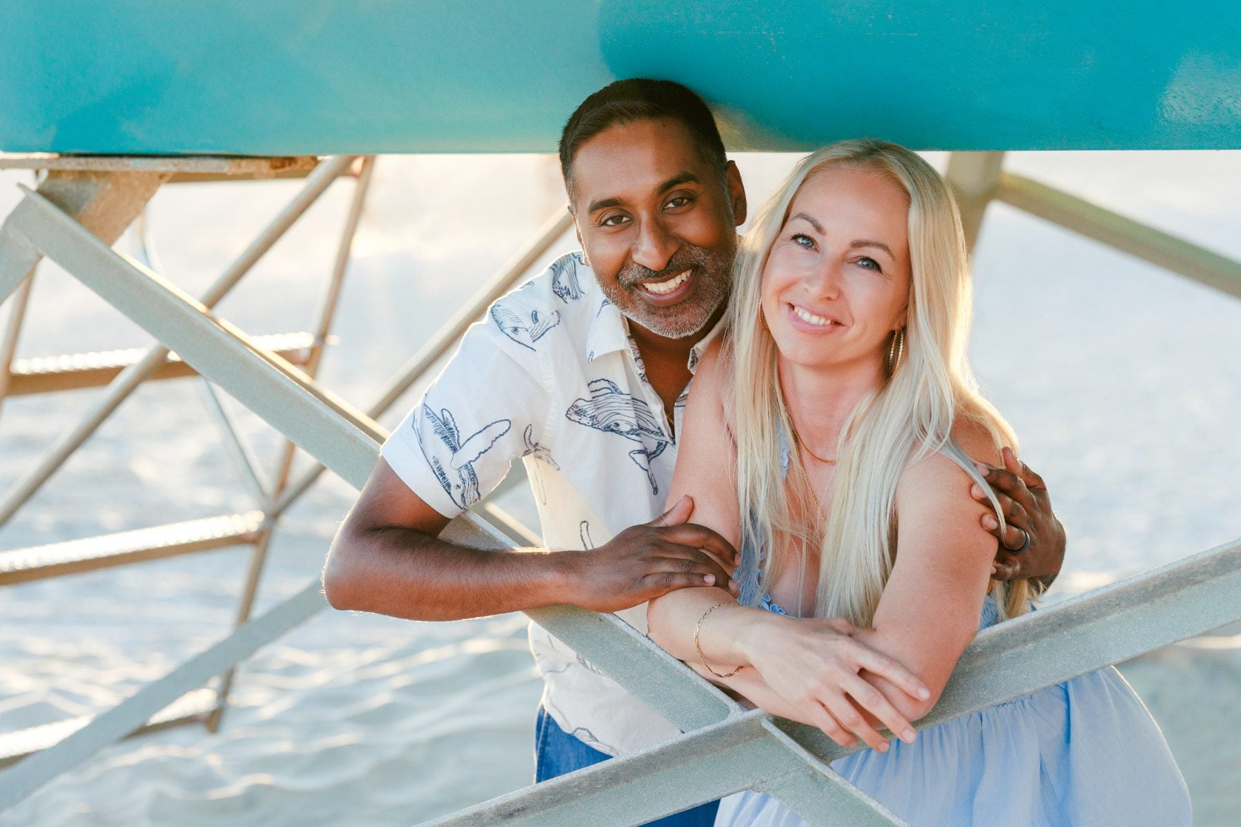 Couple embracing under a beach shade structure near Hotel del Coronado