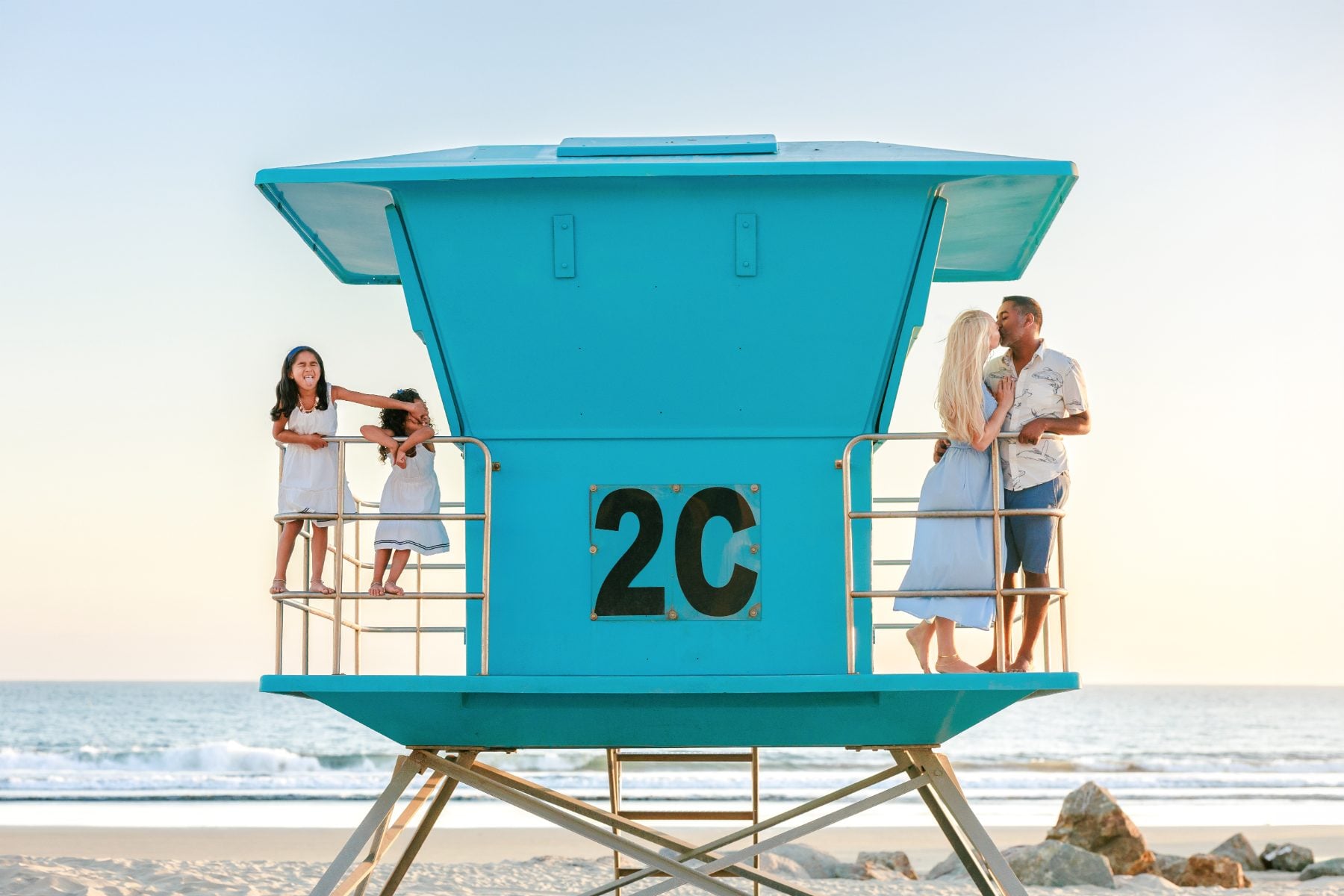 Family gathers on teal lifeguard tower 2C, Coronado beach photographer