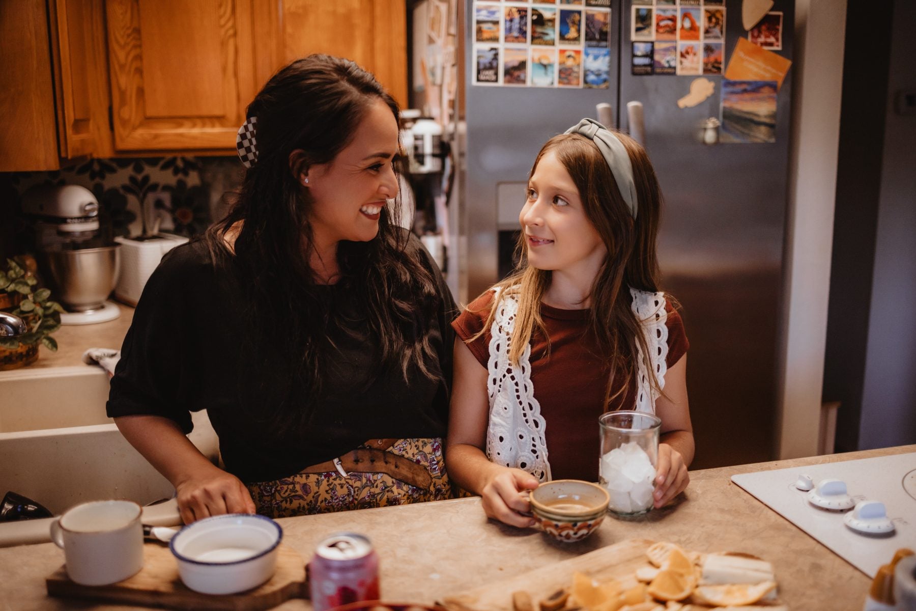 Mother and daughter laugh together at kitchen counter during Lakeside home session