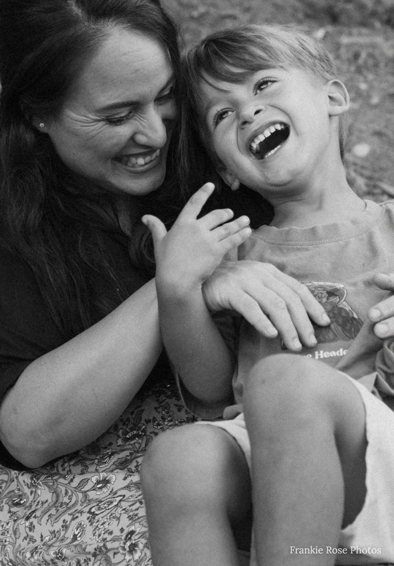 Mother and young daughter laughing together during San Diego family photographer session