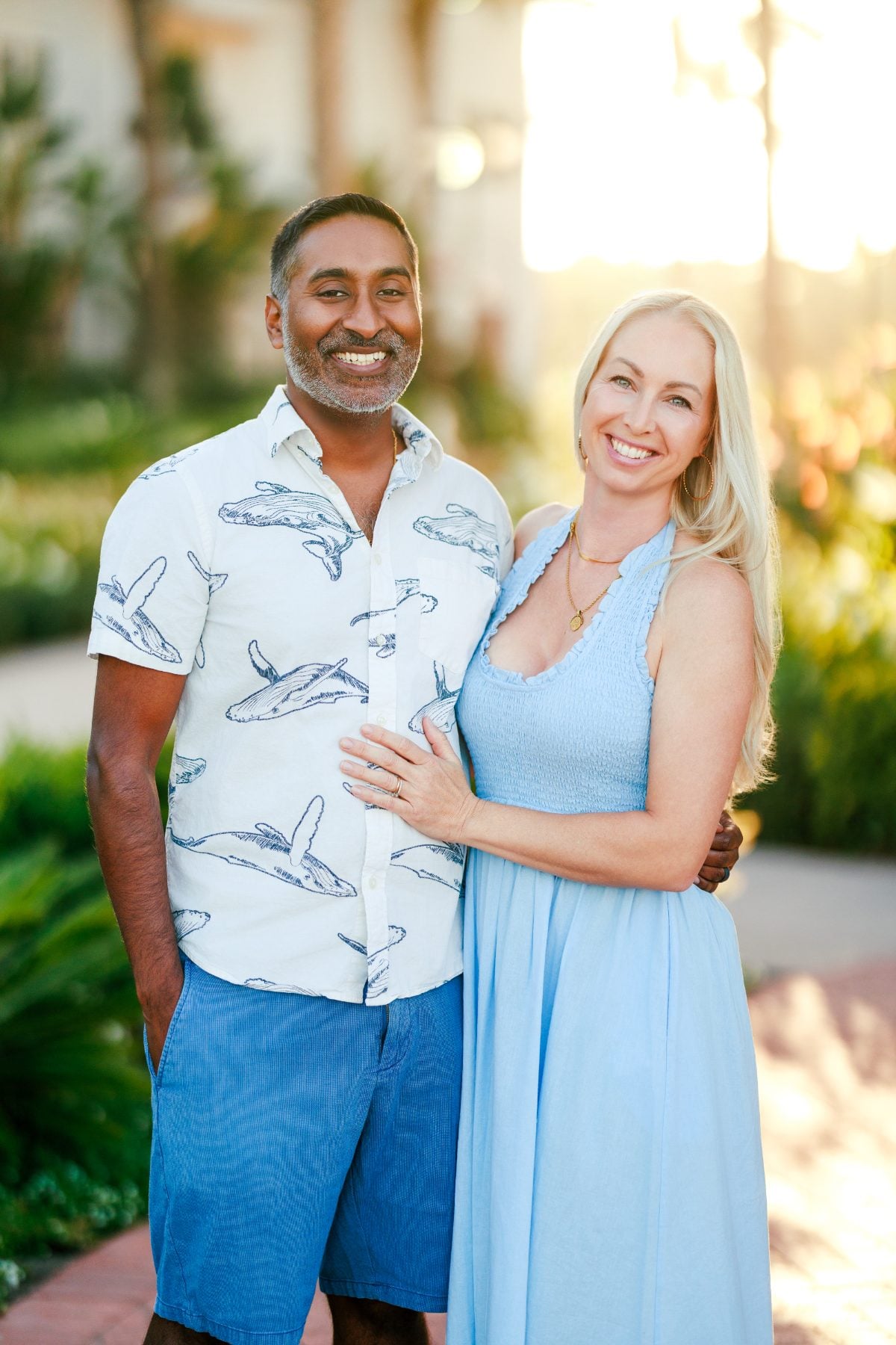Dad and mom smile together in a garden at Hotel del Coronado