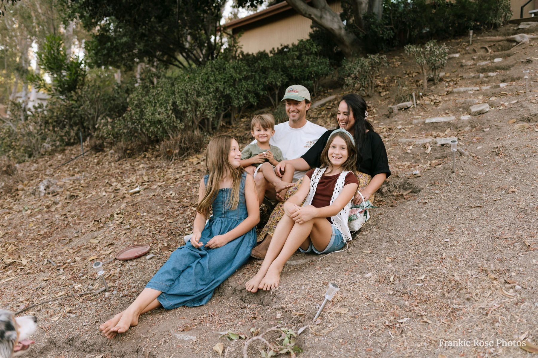 San Diego family photographer captures family smiling on hillside trail