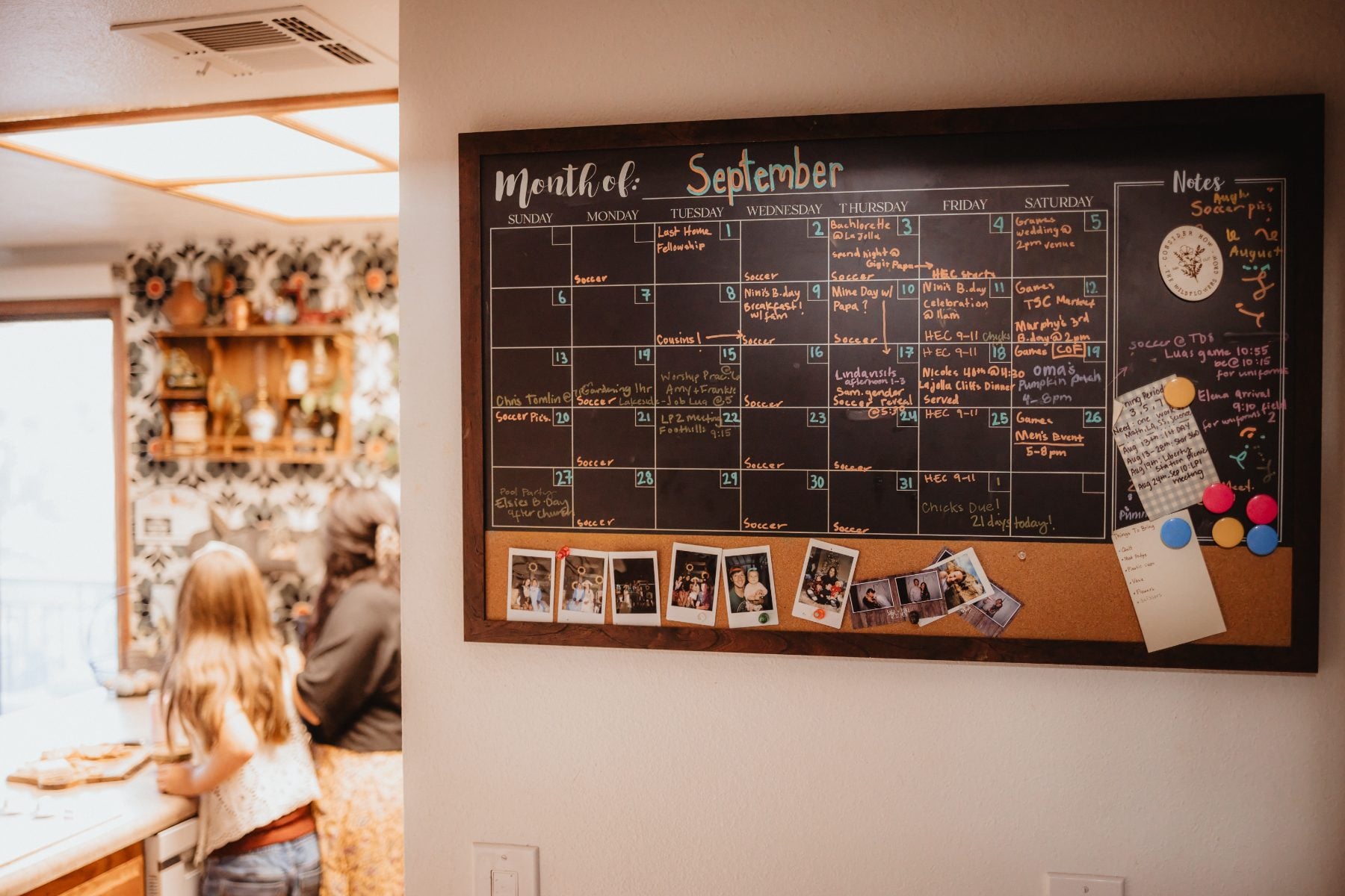 Chalkboard wall calendar tracks September family schedule in Lakeside home