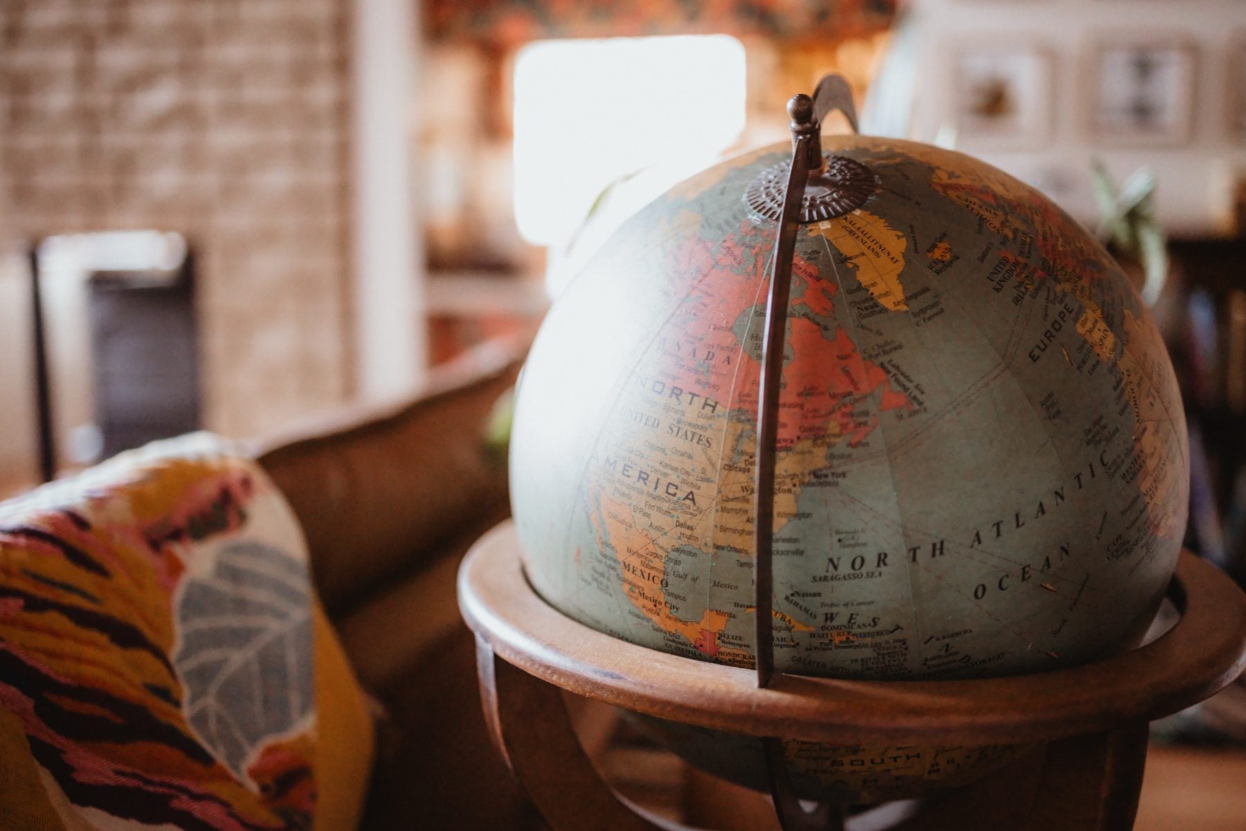 Vintage world globe on wooden stand inside a Lakeside, California home