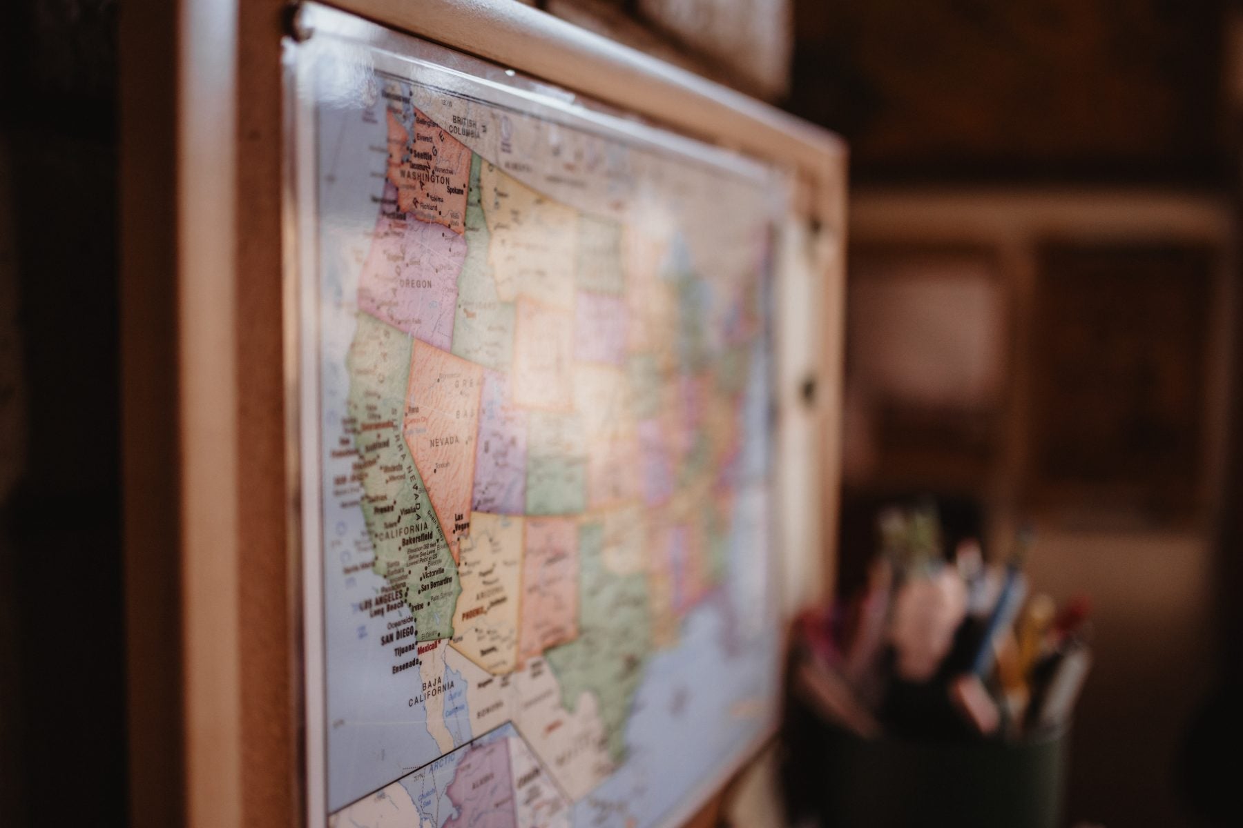Vintage US map hangs beside a pencil cup in a cozy office nook